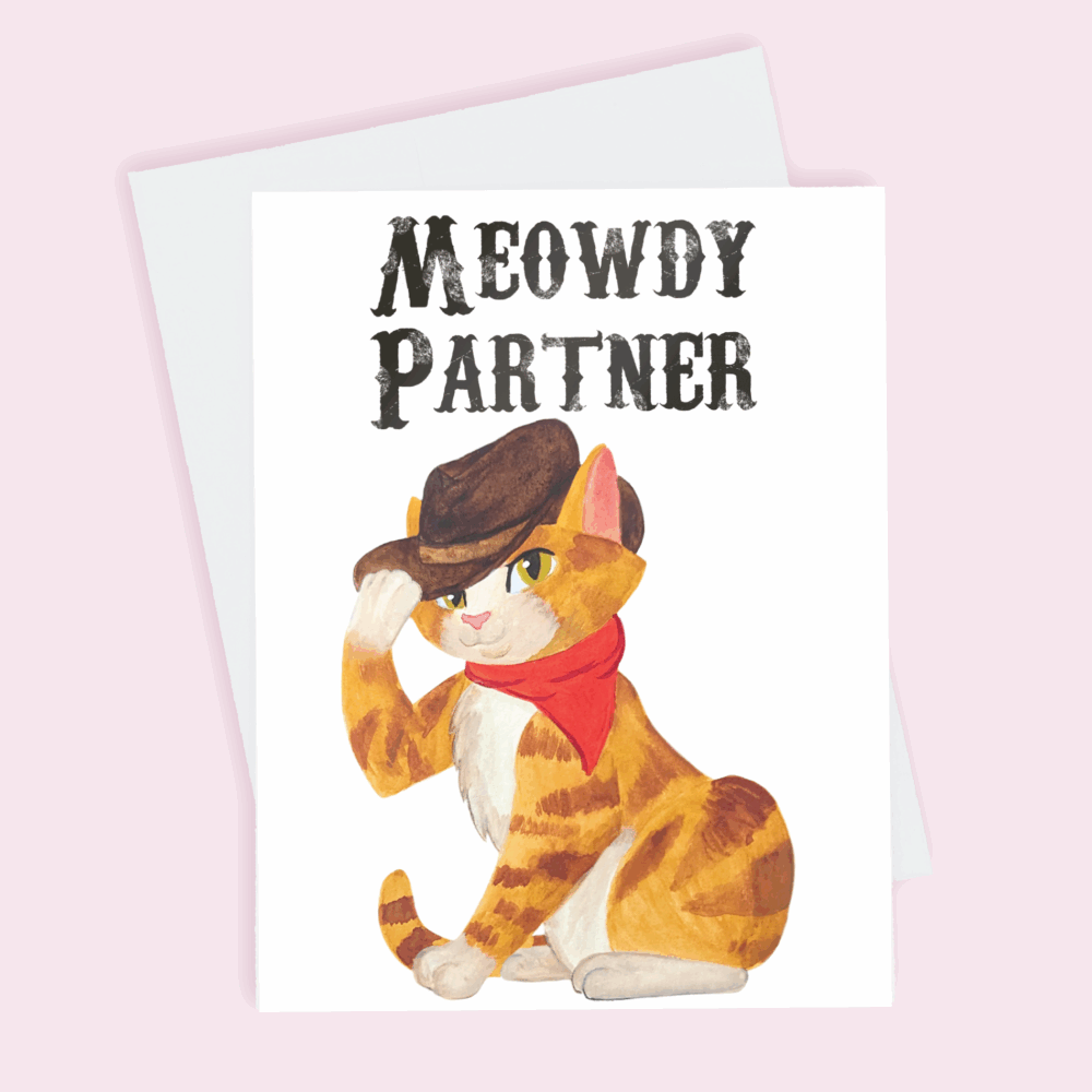 A greeting card depicting an orange tabby with a cowboy hat and red bandanna around its neck with the text above its head reading 'Meowdy Partner' done in watercolor.